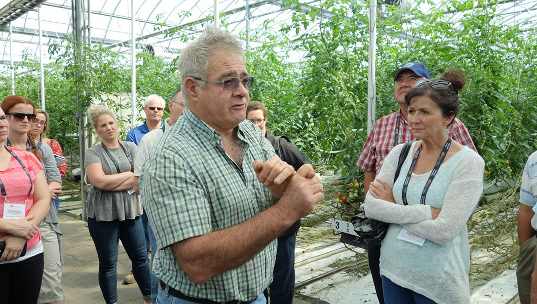Bob Mitchell, owner of SunTech greenhouses, describes the use of disinfectants to cleanse the greenhouse after the growing season, during the CHC crop protection information tour.